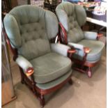 A pair of two dark oak finish high back armchairs by Joynson Holland of High Wycombe with green