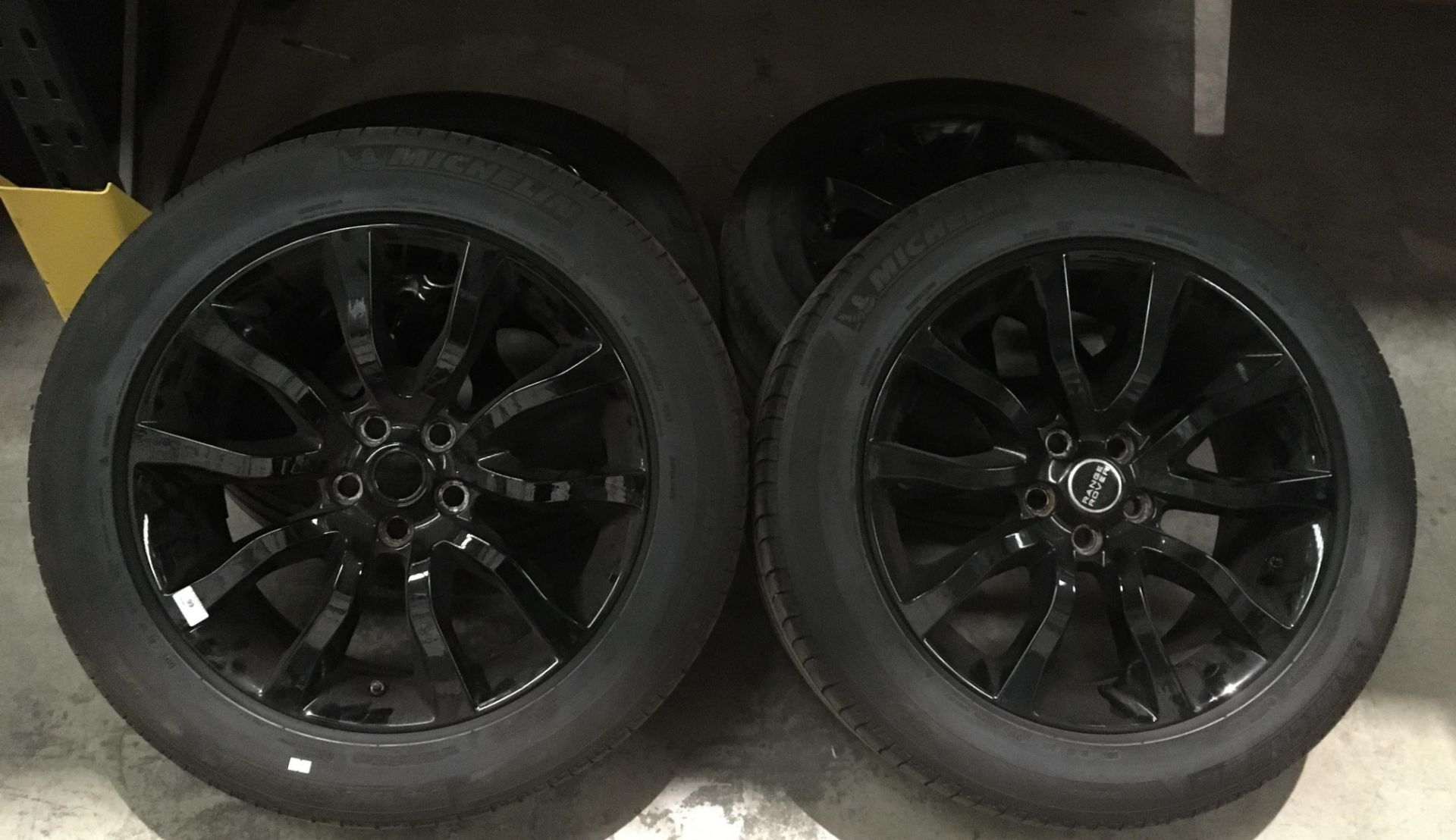 Four black alloy wheels - used (centre cap Range Rover - missing one centre cap) with four Michelin