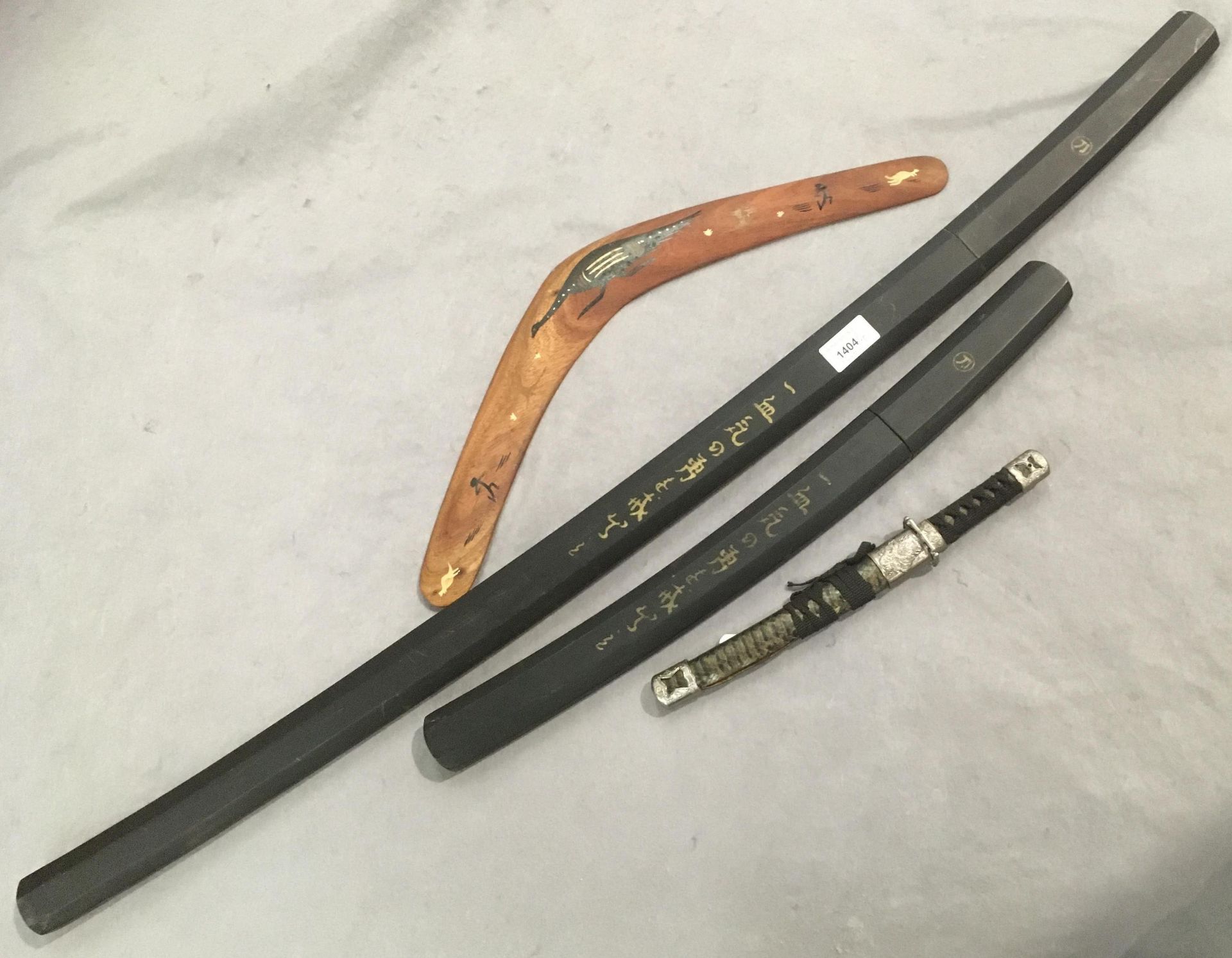 A reproduction Japanese sword in sheath, blade length 67cm, and a matching shorter sword,