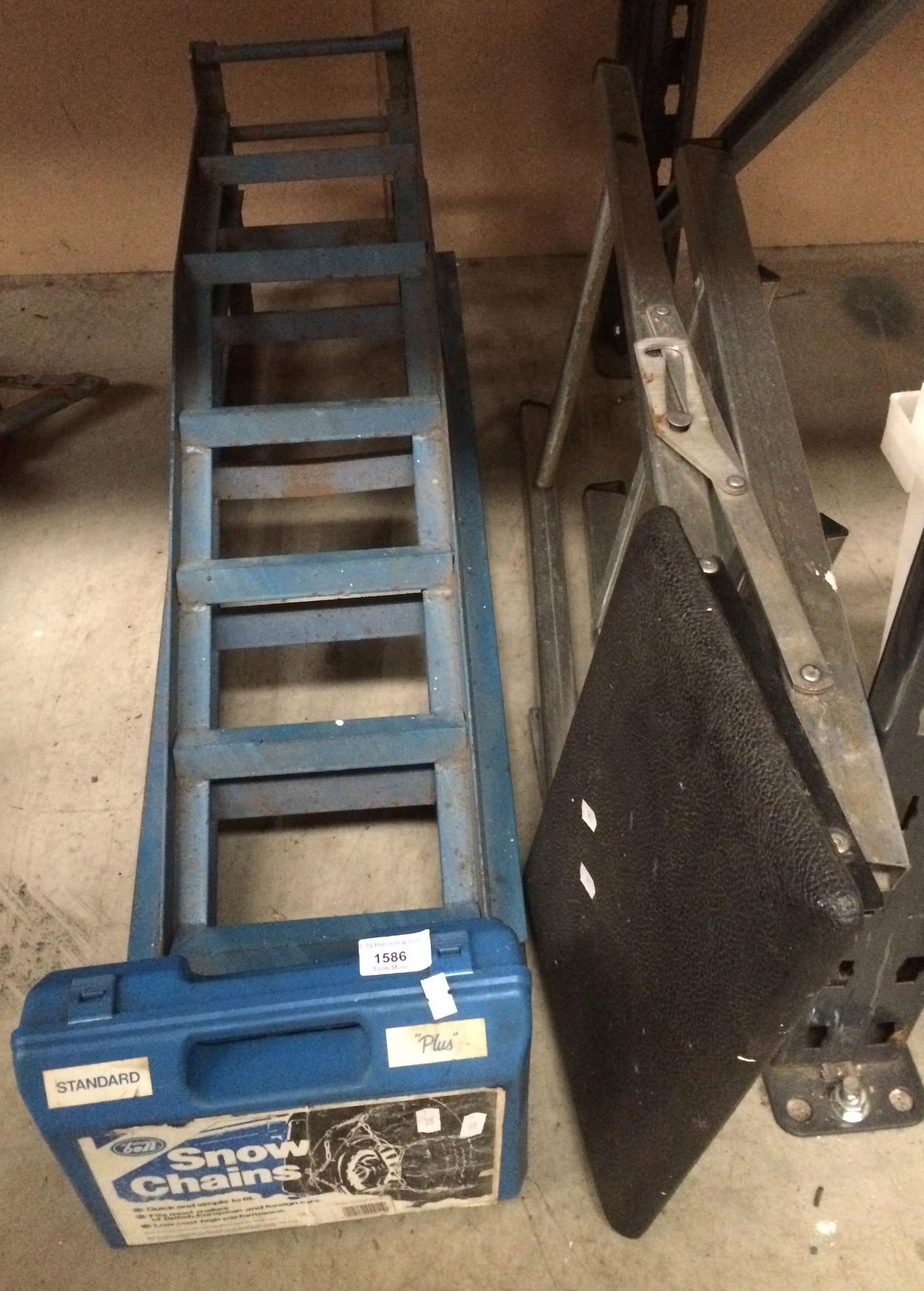 A pair of blue metal car ramps,