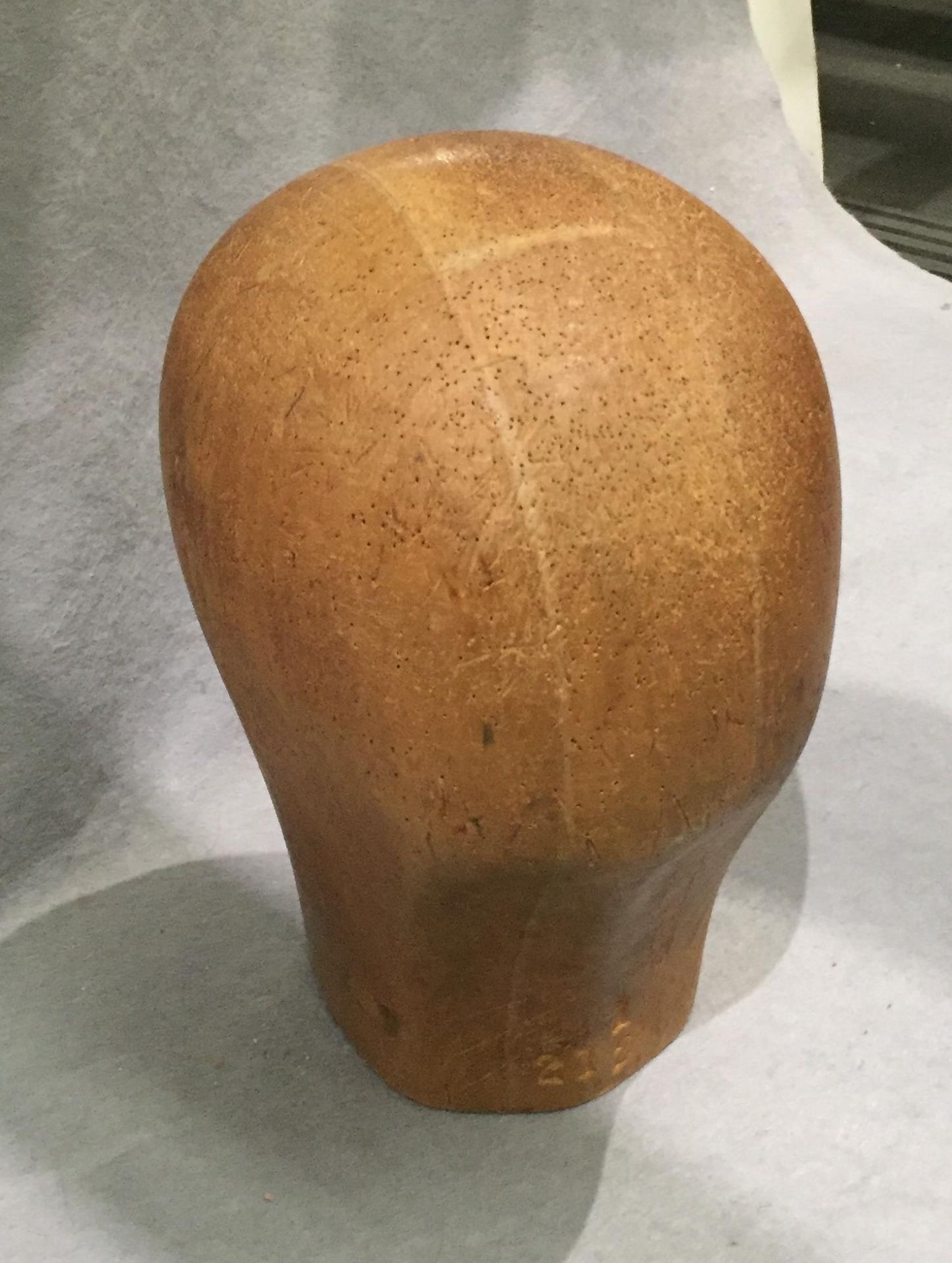 A wooden wig stand