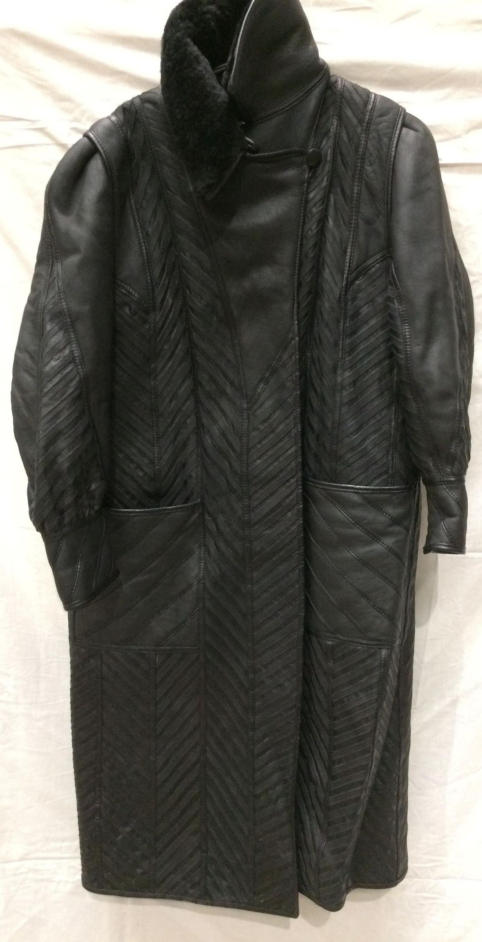 A designer lady's black leather chevron finish long trench coat (lined), no size shown,