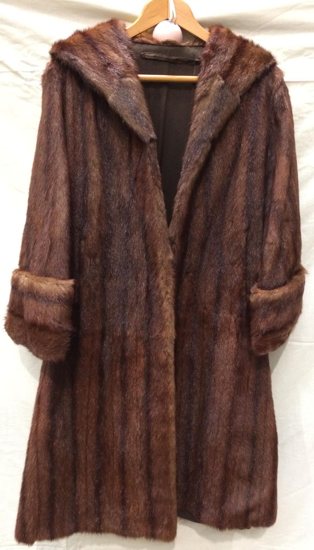 A lady's dark brown long fur coat,