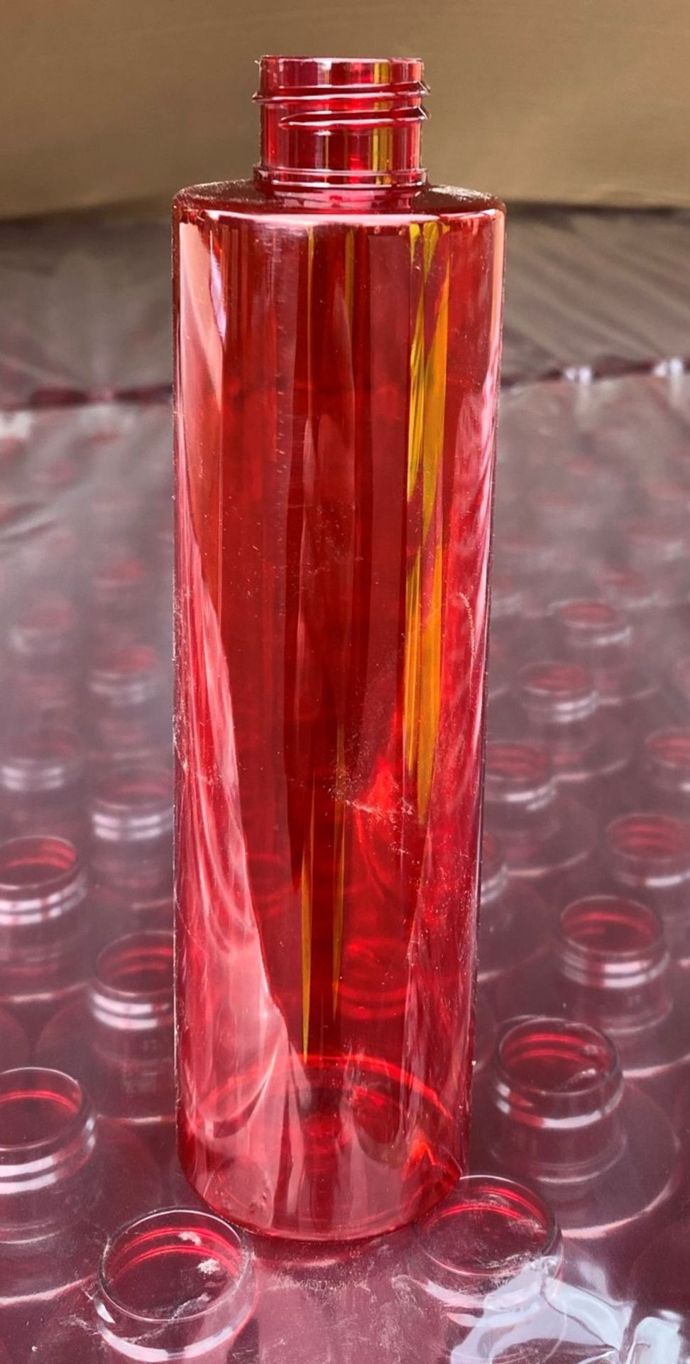 Contents to pallet - Approximately 3,060 x Red plastic cylinderical 200ml bottles - NO LIDS - (Ref.
