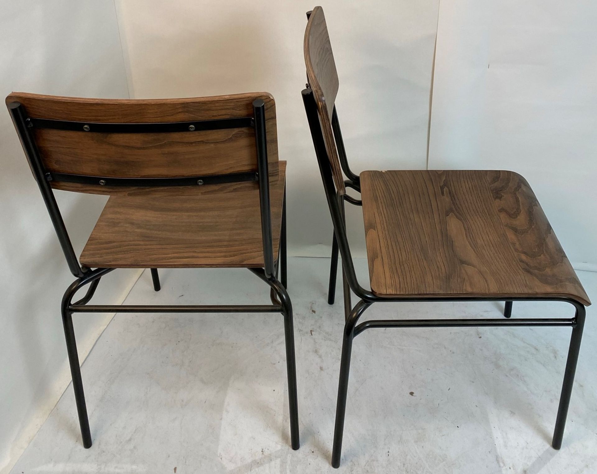 2 x Dark wood effect stacking chairs with black metal frames - Pleae note slight chip to rear right - Image 4 of 4