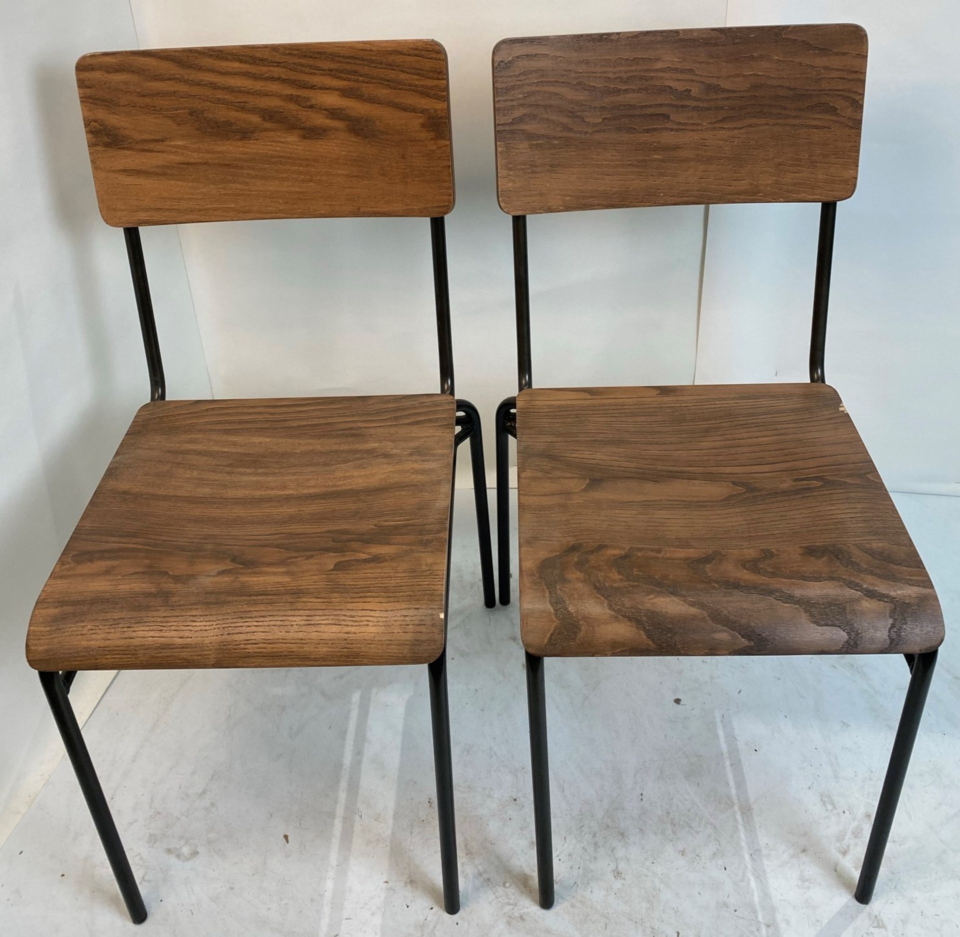 2 x Dark wood effect stacking chairs with black metal frames - Pleae note slight chip to rear right