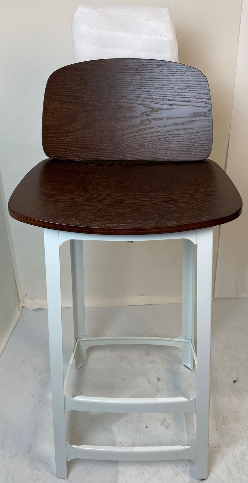 A white metal Dart high bar stool with wooden seat and back rest