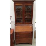 A Mahogany early 20th century bureau bookcase with two leaded Art Nouveau style glazed upper doors