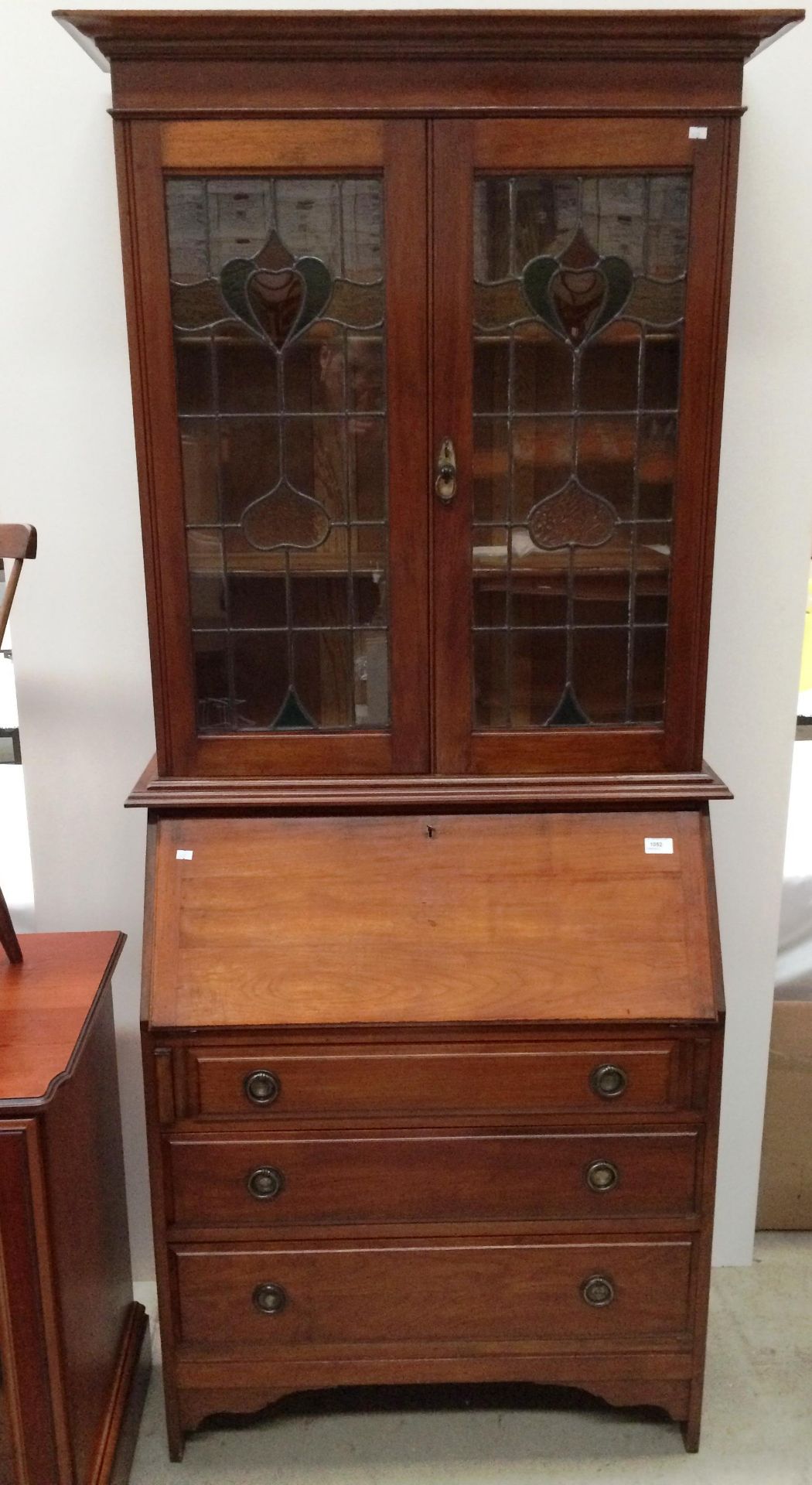 A Mahogany early 20th century bureau bookcase with two leaded Art Nouveau style glazed upper doors