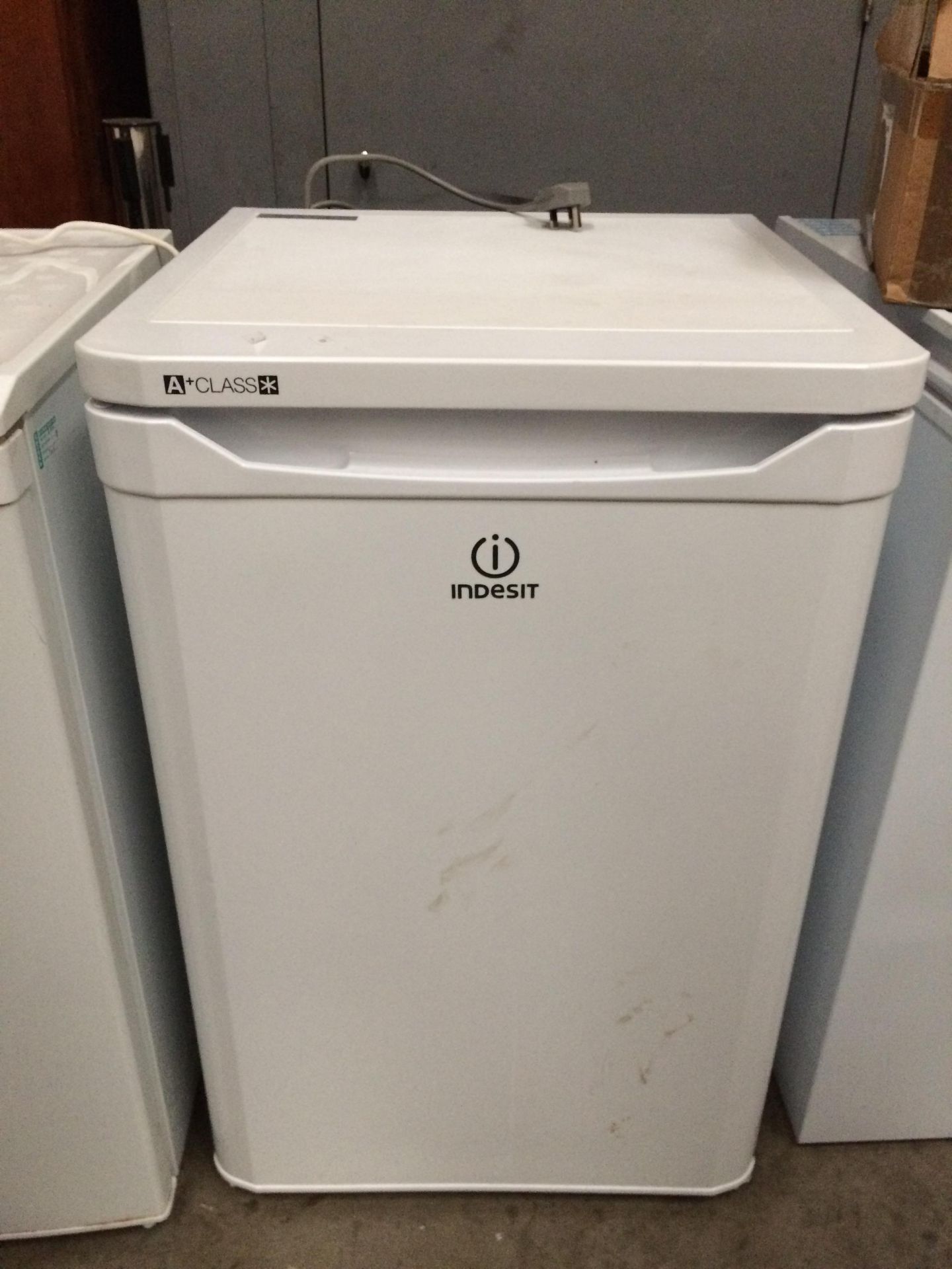 An Indesit A+ Class under counter fridge