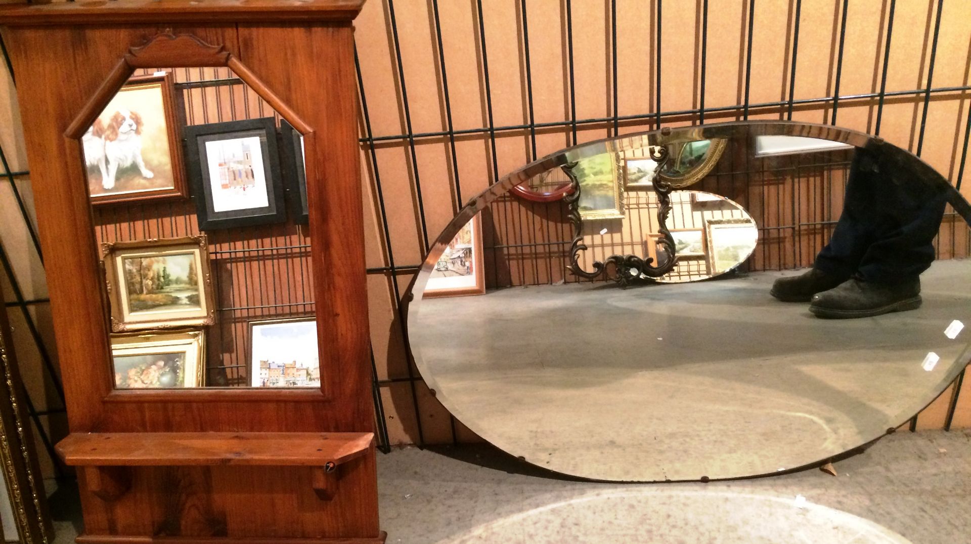 An oval framed wall mirror 80 x 54cm and a pine framed wall mirror 75 x 43 - top section loose (2)