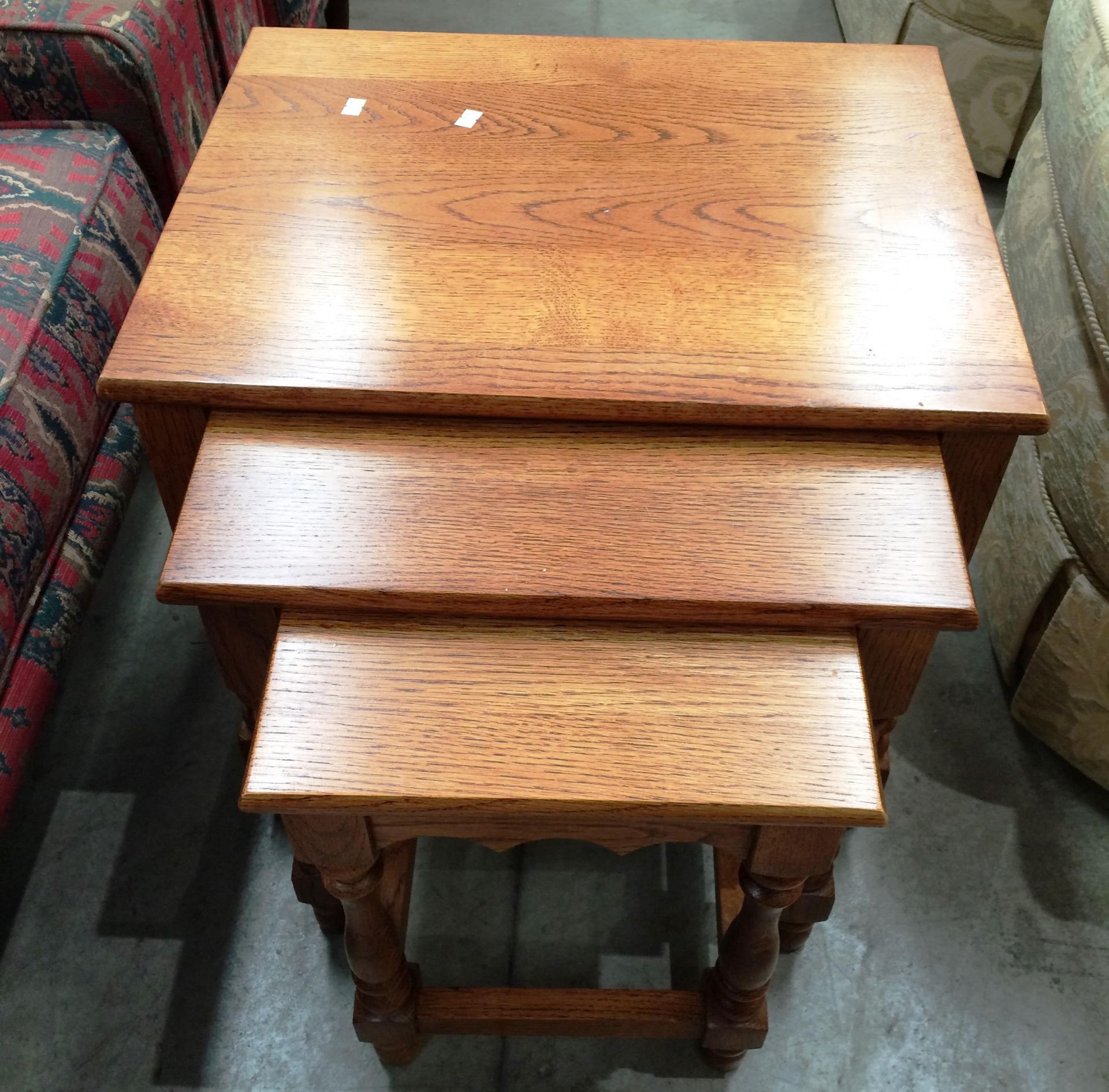 A medium oak nest of three coffee tables