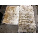 Two sheepskin style rugs one 160 x 80cm and one 110 x 80cm