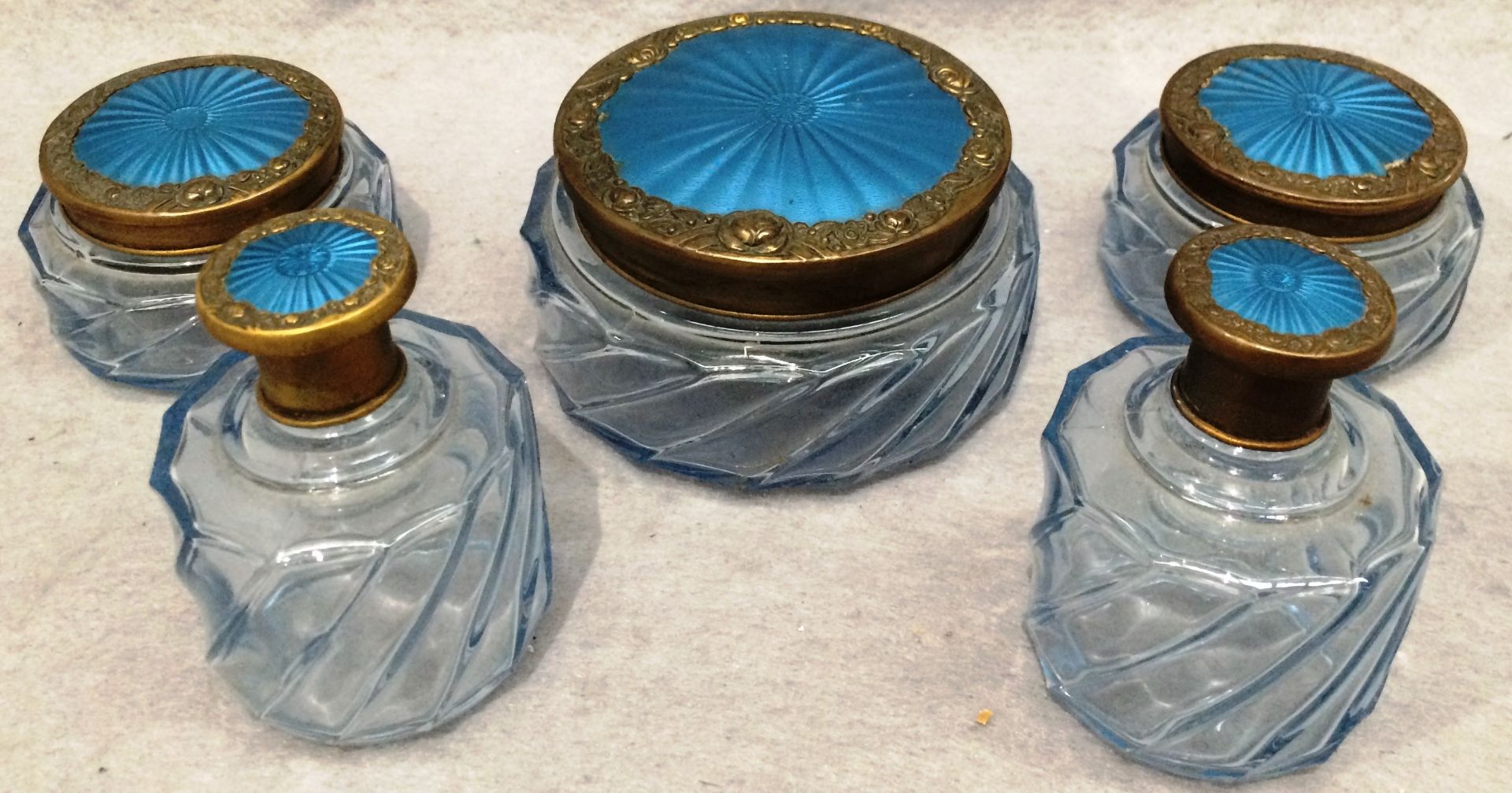 Five glass dressing table pieces with brass and blue enamel tops Further Information