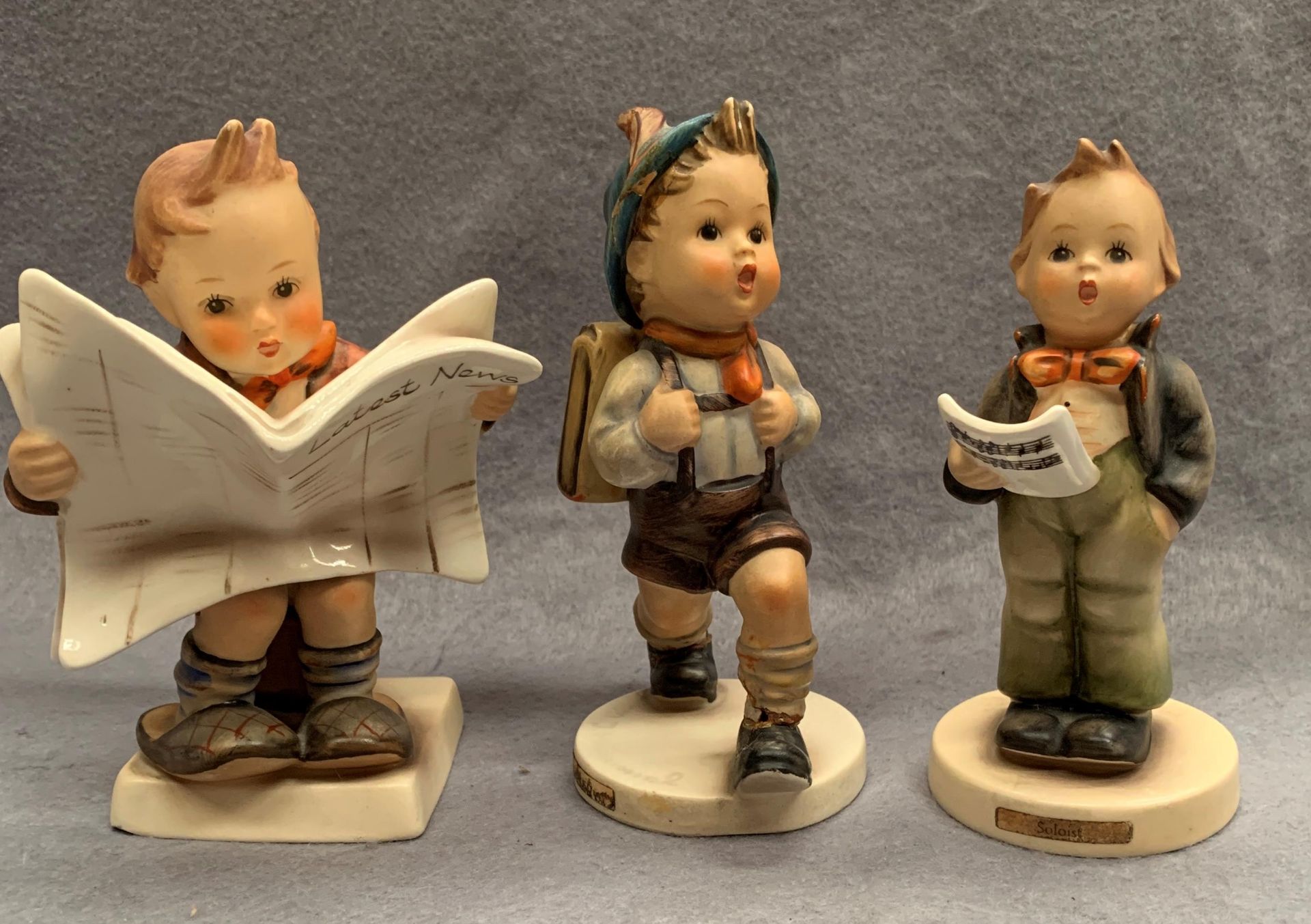 Three M J Hummel West Germany pottery figures, Breaking News, 13cm high, The Hiker, no.