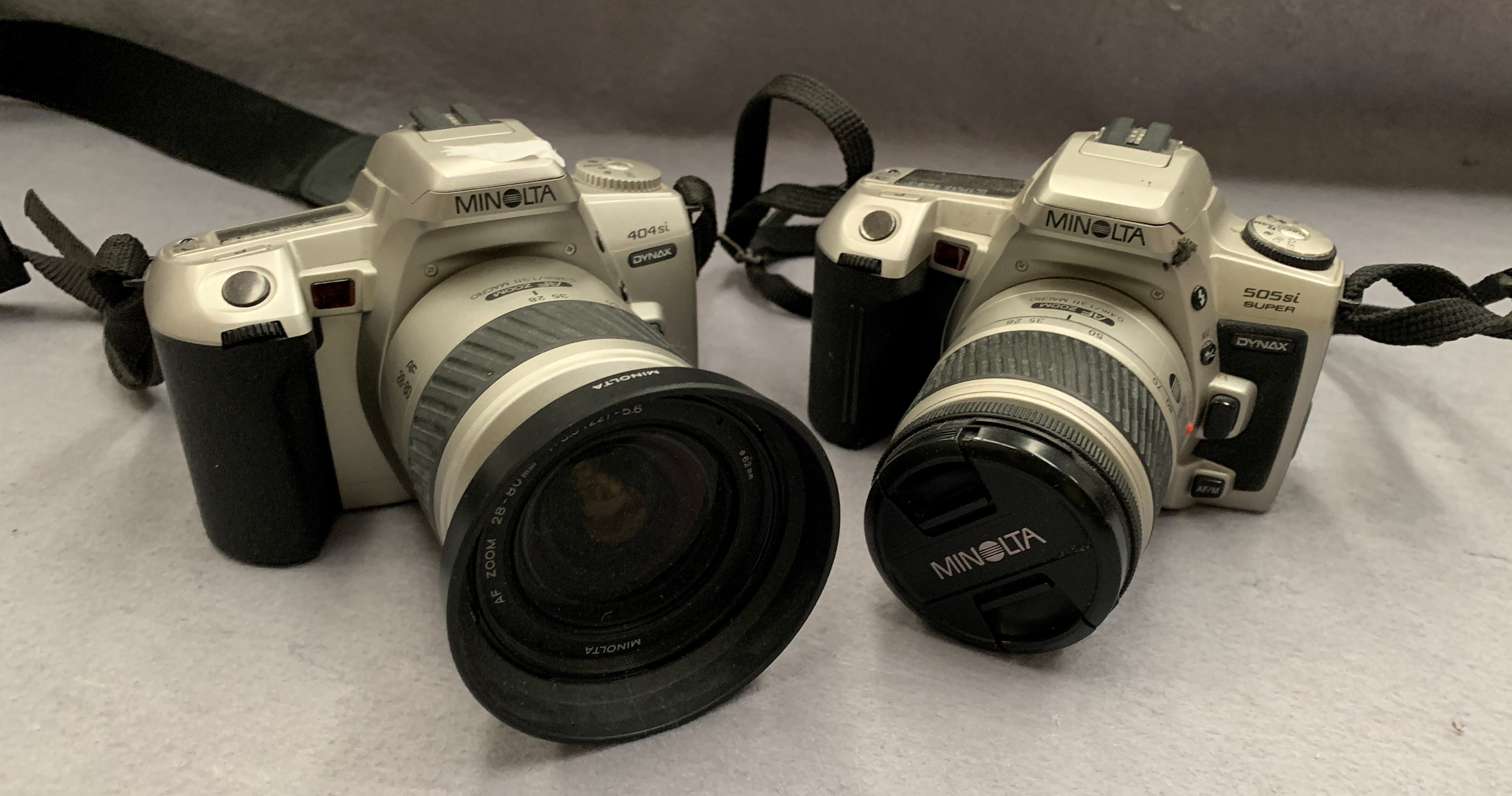 A Minolta 404Si camera fitted with a Minolta AF Zoom 28-80mm lens and a Minolta 505Si camera fitted