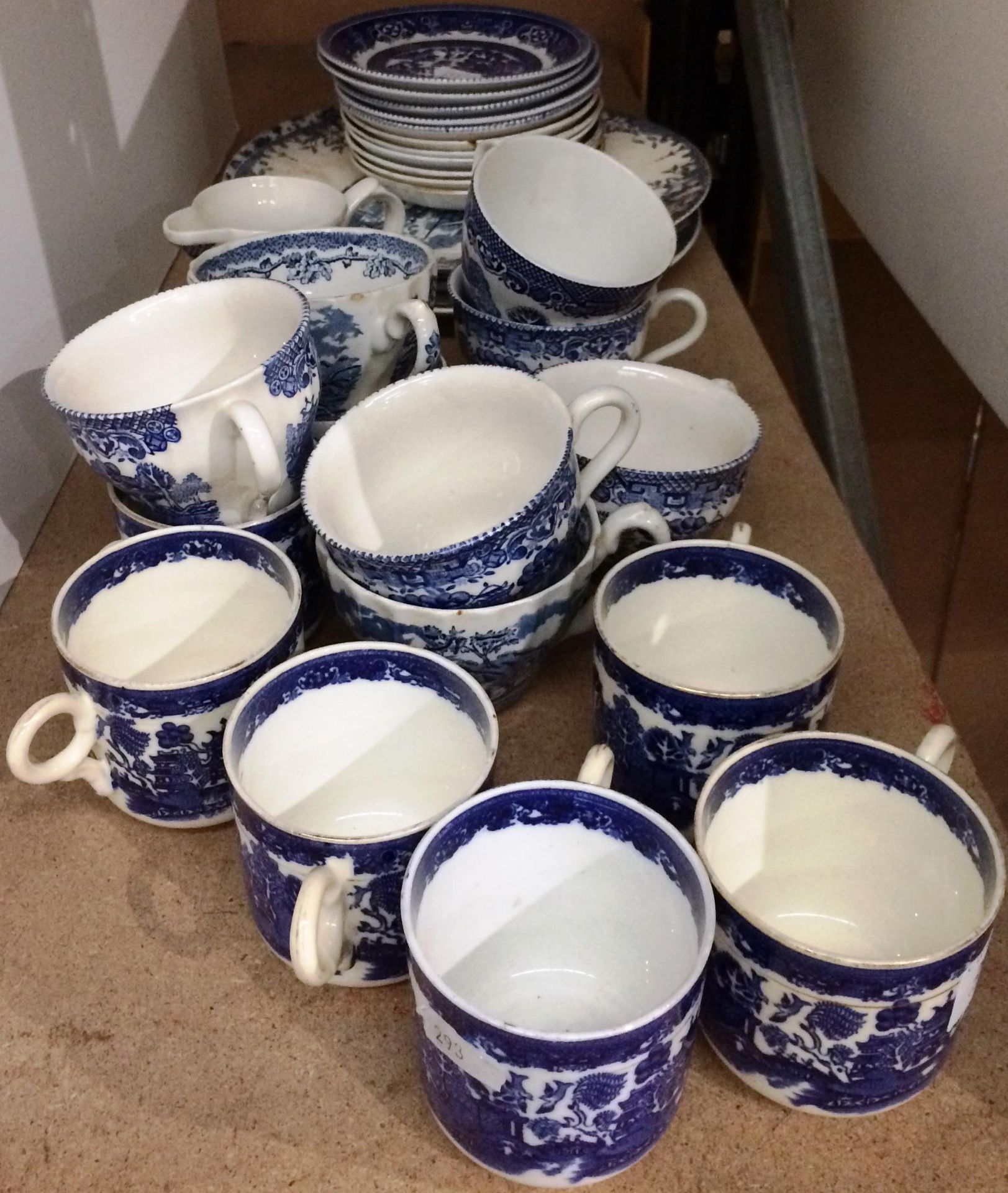 Twenty eight pieces of blue and white and willow pattern tea cups and saucers etc.