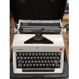 An Olympia International portable typewriter in case