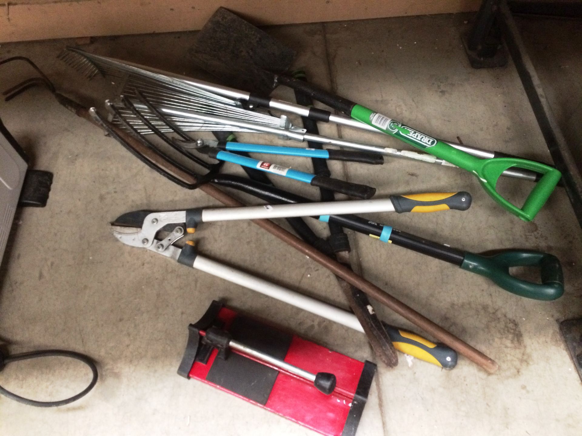 Quantity of assorted garden tools including forks, spades, rakes, croppers etc.