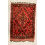 A small red ground patterned prayer mat 42 x 62cm