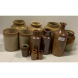A collection of twelve various sized brown glazed stoneware storage jars and bottles