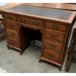 A stained mahogany nine drawer knee hole desk with brown leather finish incised top 105 x 50cm