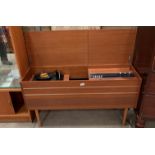 A Bush radiogram in teak finish case 116 x 64cm high - please note turns on but needs attention