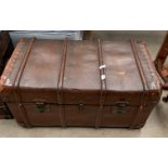 A wood and leather framed brown fibre trunk with label W.