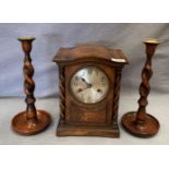 An oak mantel clock 29cm high together with two oak barley twist candle sticks