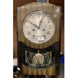 A Polaris 15 day wall clock in painted wood case 45cm complete with key