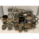 A collection of 27 assorted steins and pottery beer tankards