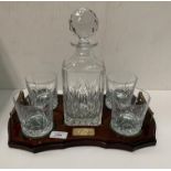 A presentation whisky decanter and four whisky tumblers on a wood tray with brass plaque 'Winner