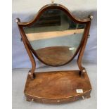 A mahogany shield shaped swing top toilet mirror with three under drawers