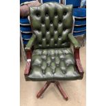 A green leather deep buttoned reproduction swivel armchair