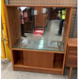 A mahogany finish bookcase unit with two glazed sliding doors over two door base 92 x 112cm label