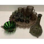 A wire work tray and contents small green/blue decanters and six wine glasses with wire detail,