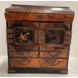 A reproduction table top oriental lacquered cabinet with lift top,