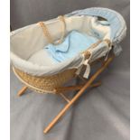 One moses basket 88cm long on stand complete with blue bedding