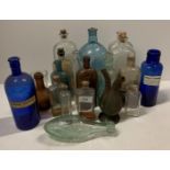 A collection of nineteen glass chemist and other bottles - some coloured,