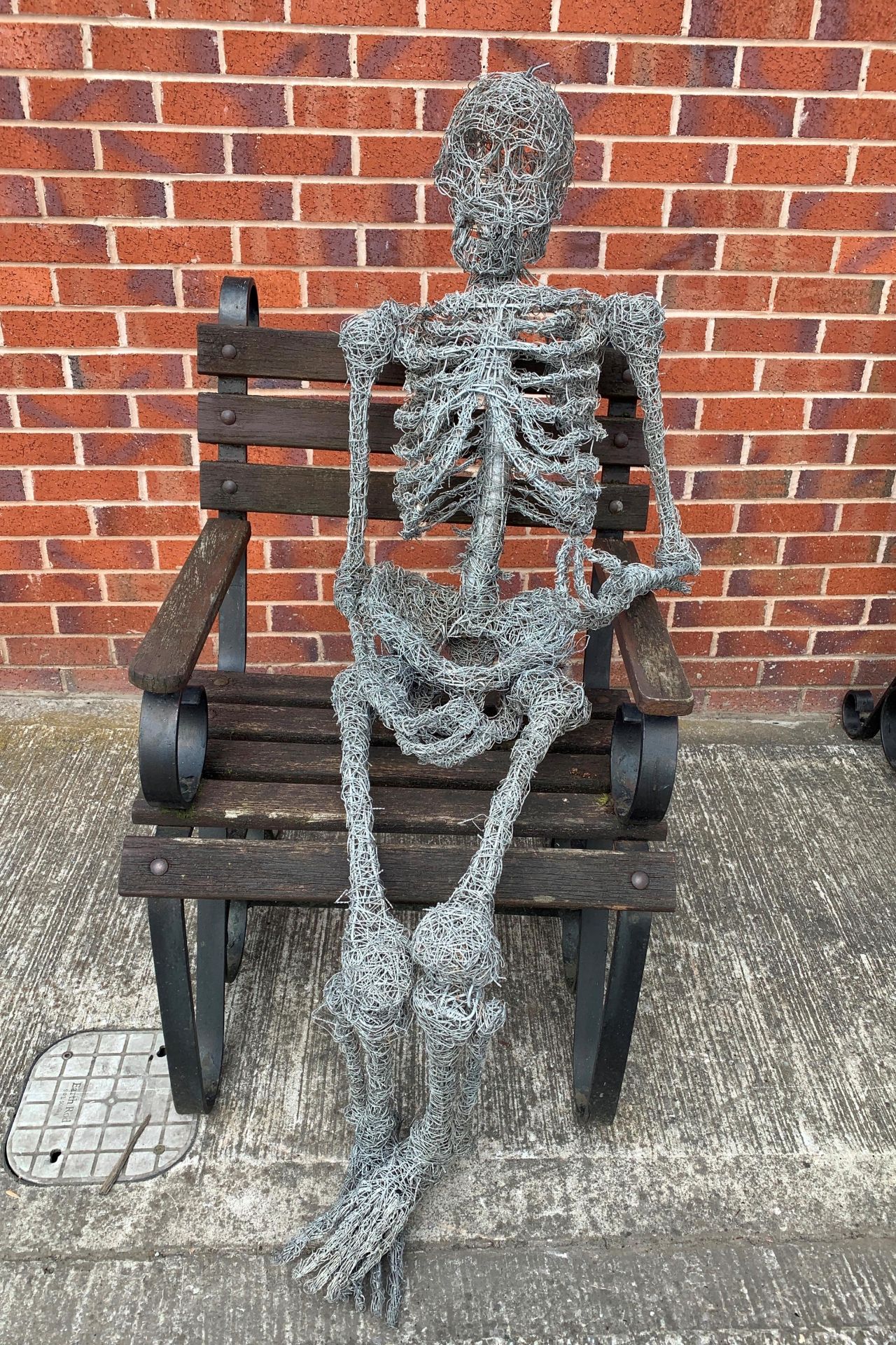 A lifesize wirework model of a seated skeleton total height approx 130cm