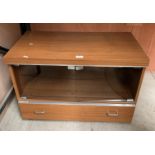 A teak finish entertainment stand with two smoked glass doors over two drawers