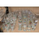 Contents to part of rack a large quantity of German beer drinking glasses in various shapes and
