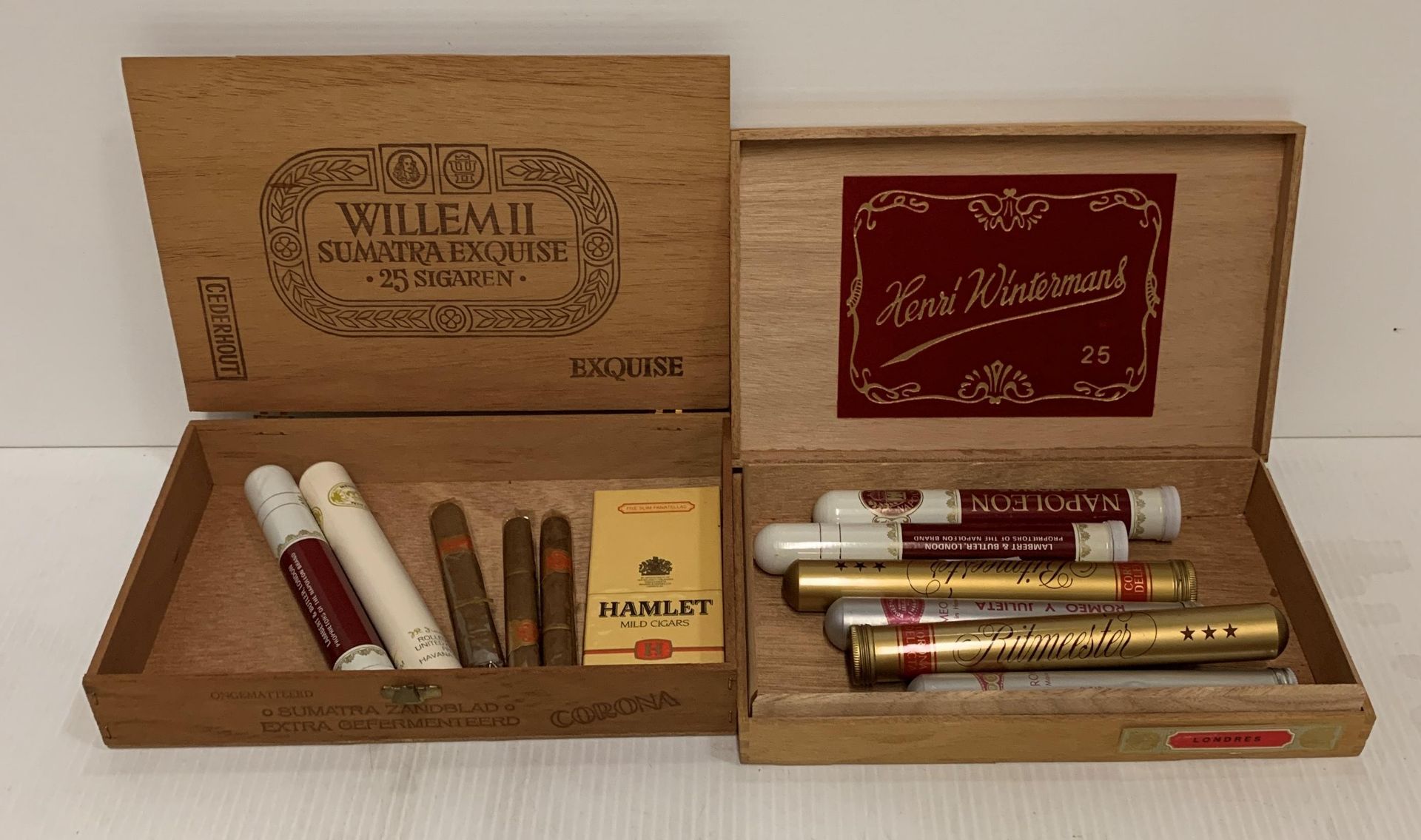 Two cigar boxes containing eight individual cigars in cylinders (3 Napoleon Coronas,