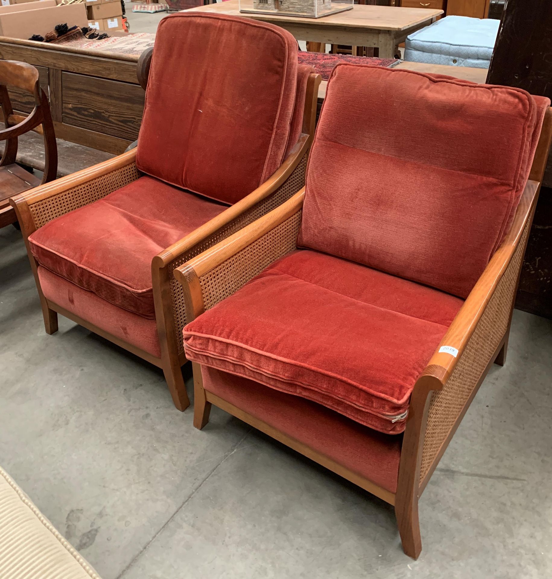 Two Parker Knoll Bergere style medium wood finish armchairs with pink upholstered seat and back