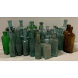 A collection of 40 glass chemists bottles mainly light green ribbed,