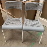 Two grey plastic stacking chairs on white metal frames *please note this lot is subject to VAT