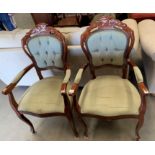 A pair of Continental style medium wood finish armchairs with light green buttoned back back pad