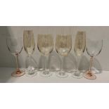 Thirteen large wine glasses with etched decoration,