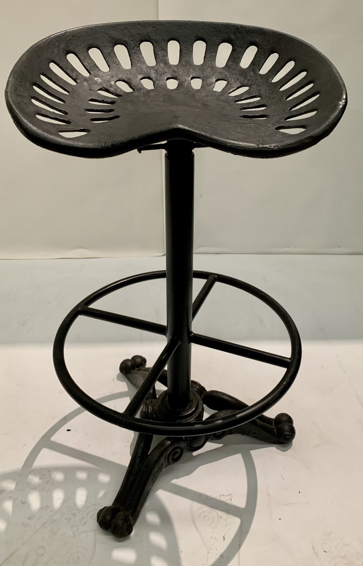 1 x heavy wrought iron adjustable bar stool with foot rest on trefoil base - adjustable height
