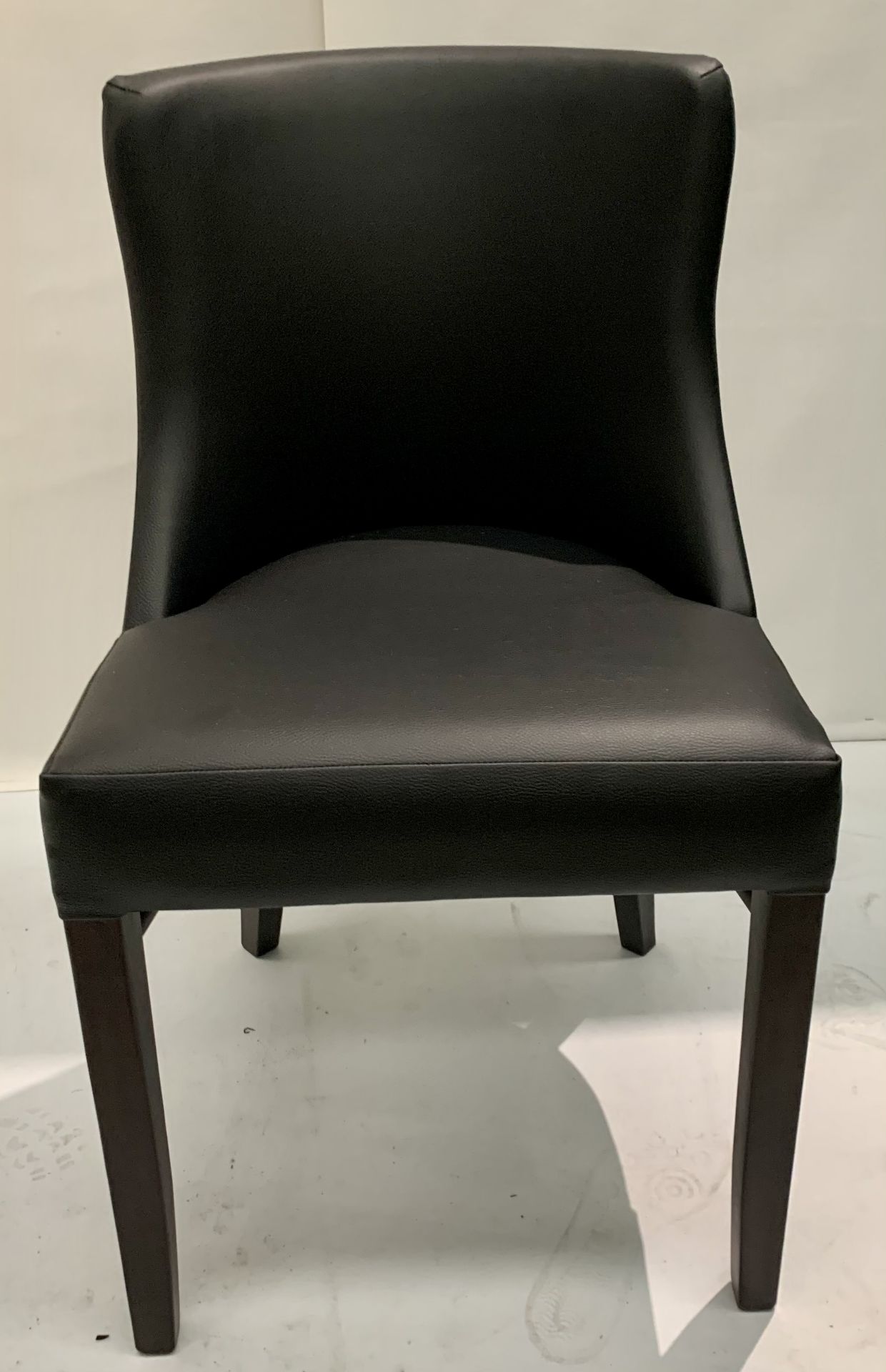 1 x Leona walnut coloured framed dining chair with black leather effect seat